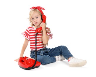 Photo of Cute little girl with telephone on white background