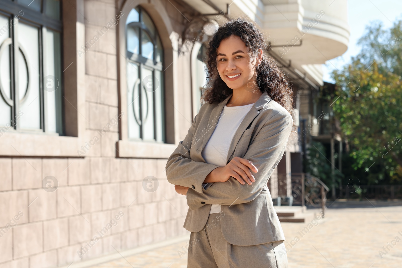 Photo of Portrait of young woman wearing stylish suit outdoors