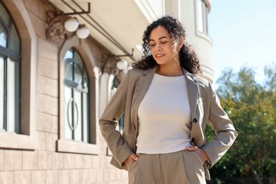 Photo of Portrait of young woman wearing stylish suit outdoors