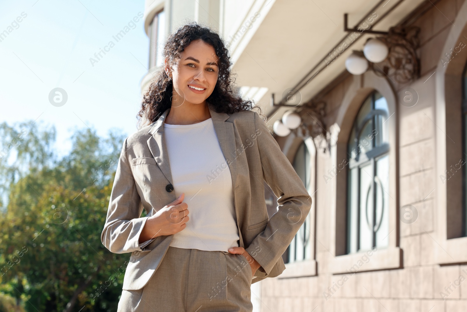 Photo of Portrait of young woman wearing stylish suit outdoors