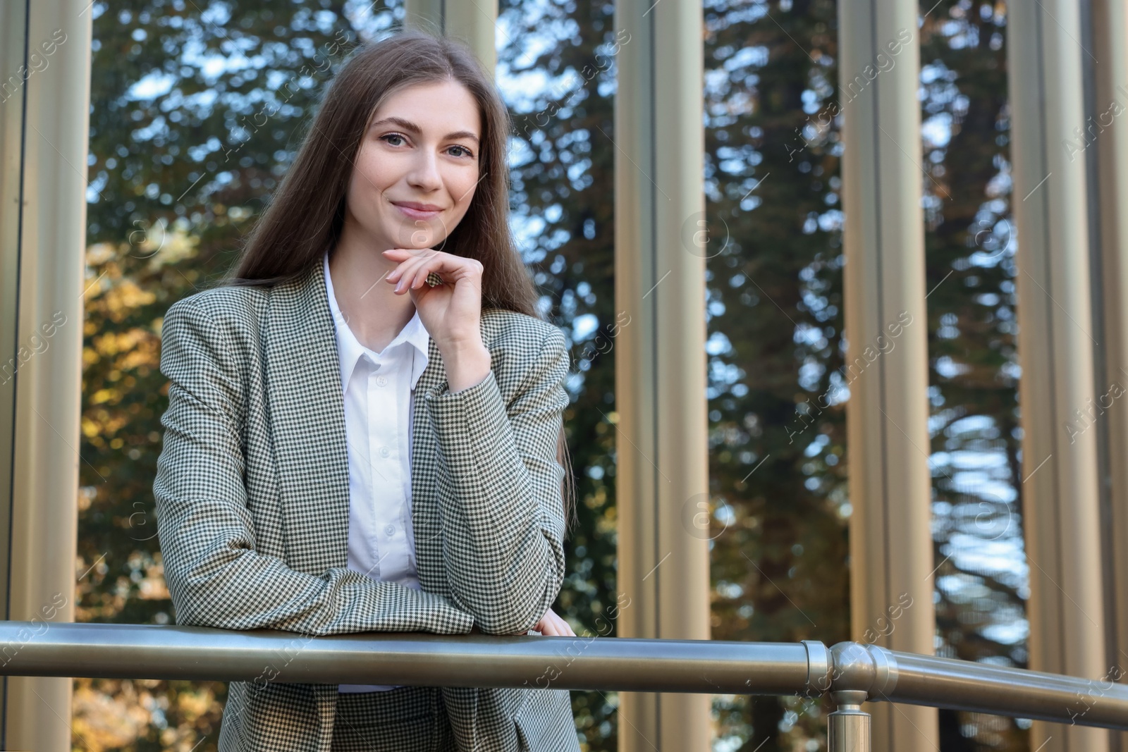 Photo of Portrait of young woman wearing stylish suit outdoors