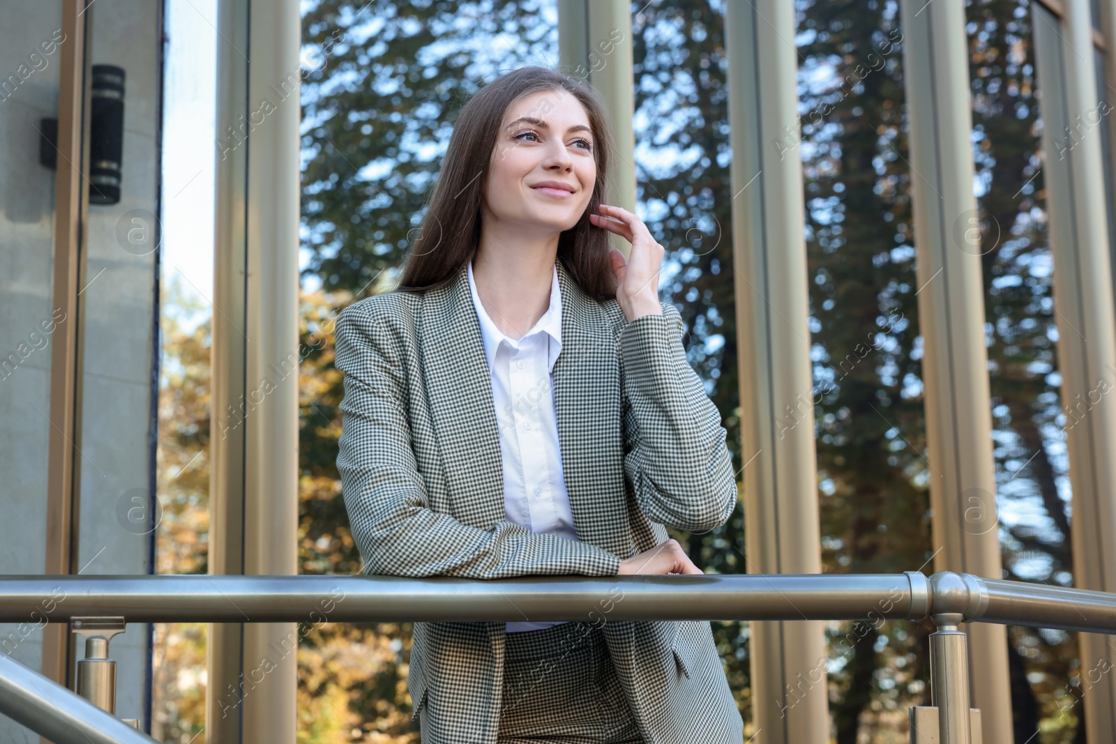 Photo of Portrait of young woman wearing stylish suit outdoors