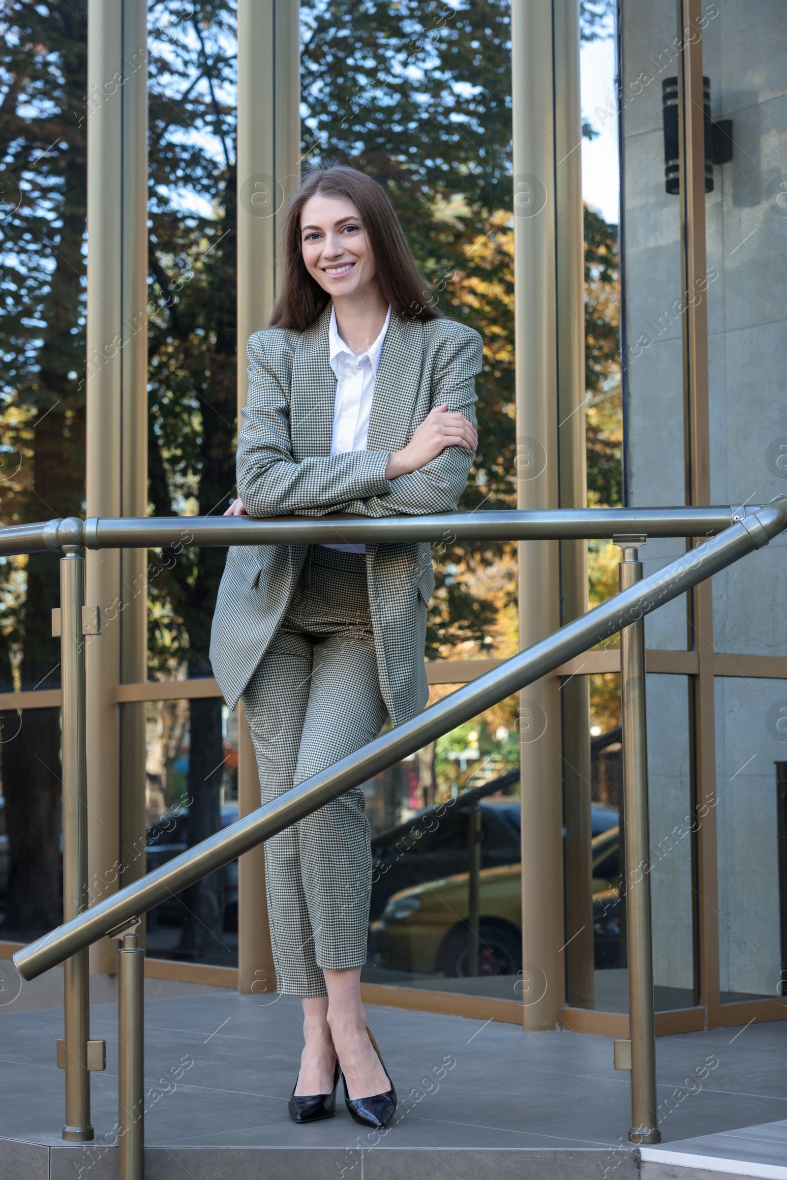 Photo of Portrait of young woman wearing stylish suit outdoors