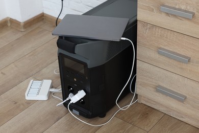 Modern portable power station, charging attached devices indoors