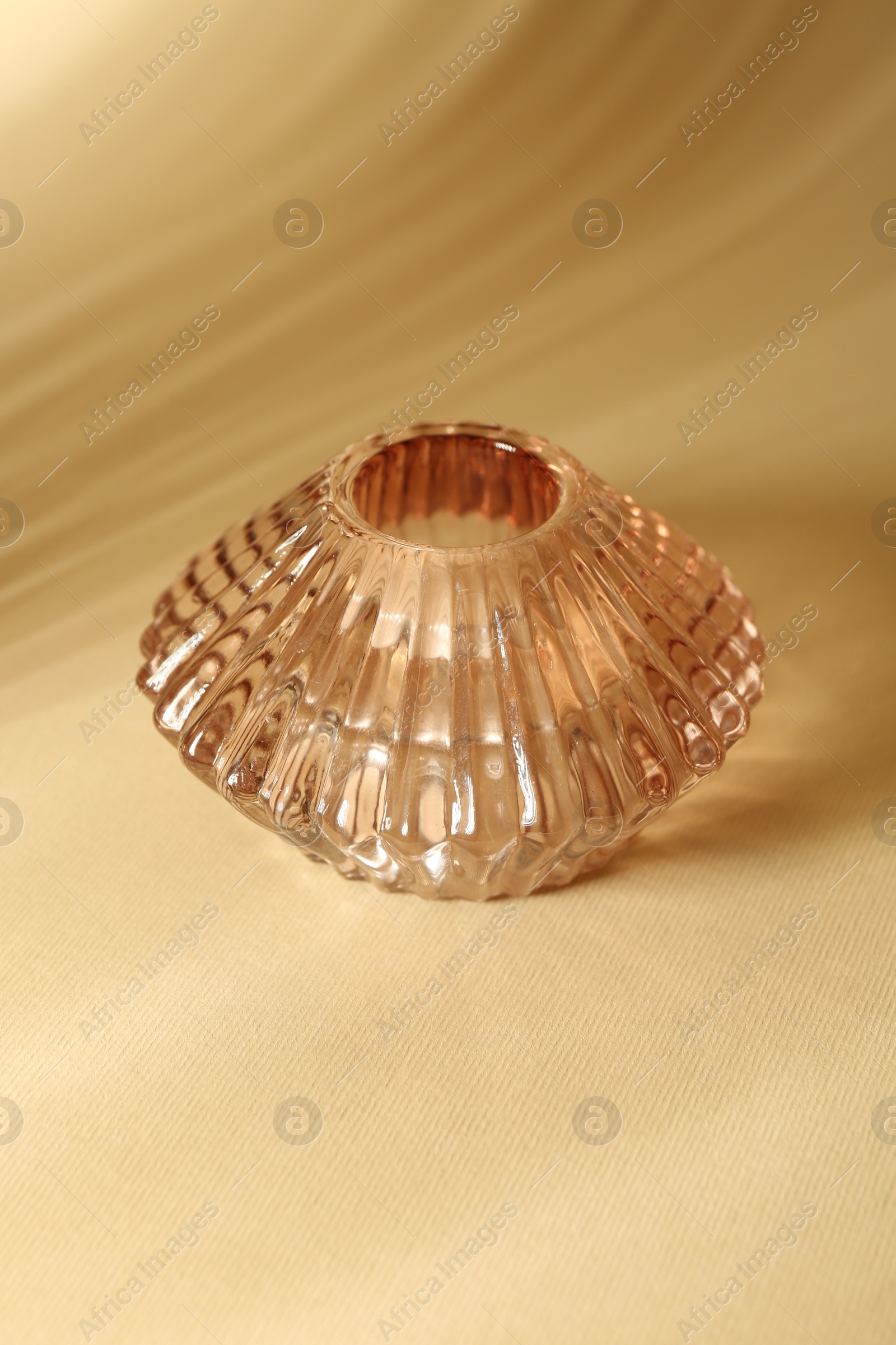 Photo of One empty glass vase on beige background