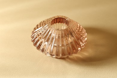 Photo of Empty glass vase on beige background, closeup