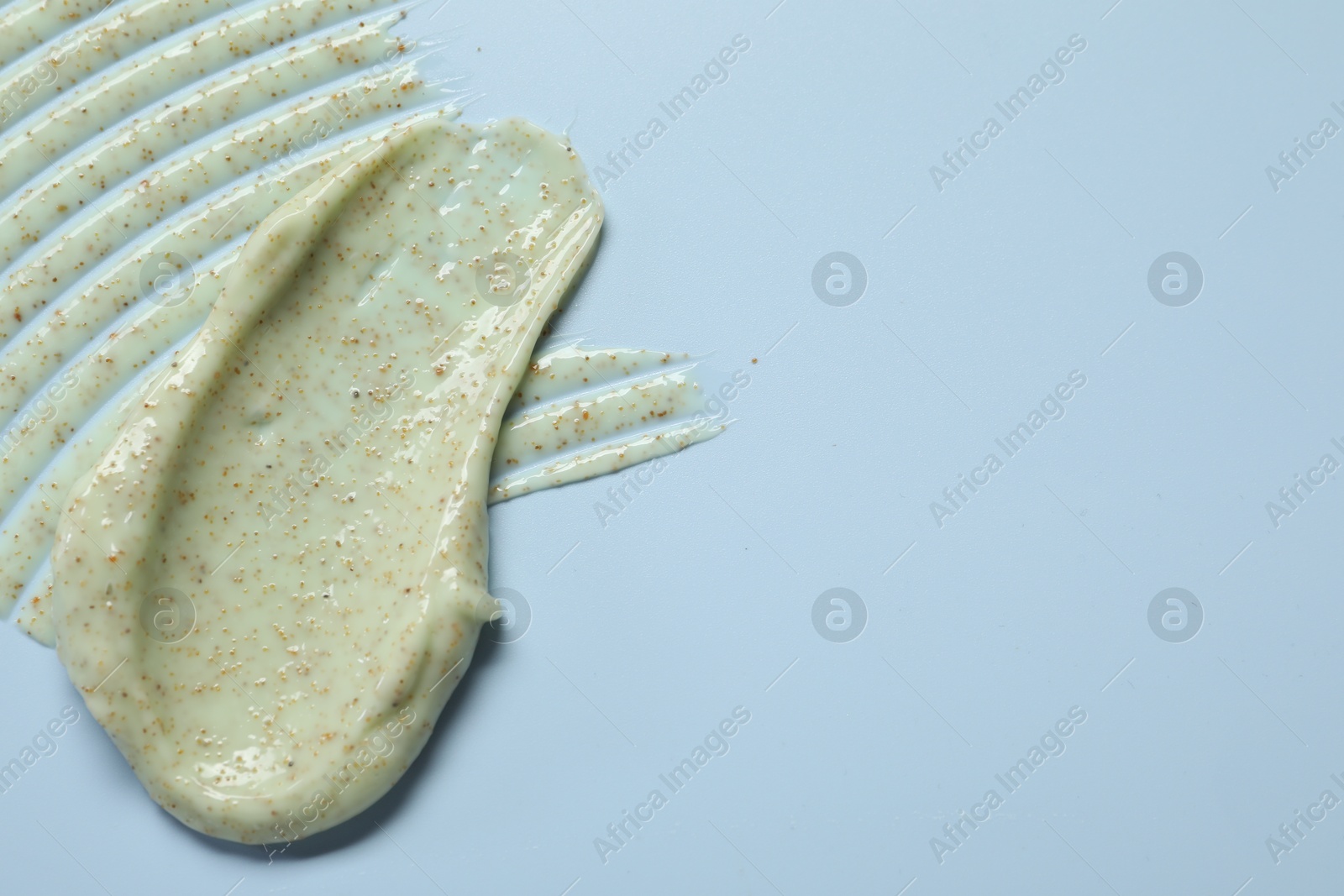 Photo of Sample of body scrub on light background, top view. Space for text