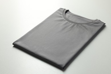 Photo of Blank grey t-shirt on white background, closeup. Mockup for design