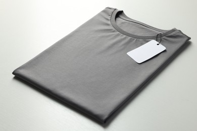 Photo of Blank grey t-shirt on white background, closeup. Mockup for design