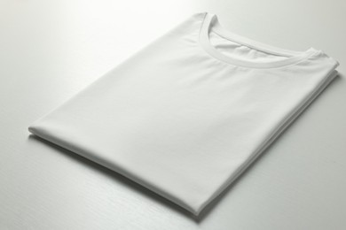 Blank t-shirt on white background, closeup. Mockup for design