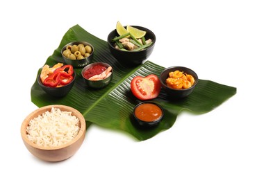 Photo of Cut banana leaf with different food and sauce isolated on white. Healthy eco serving