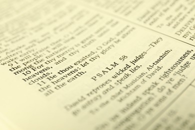 Photo of Open Holy Bible in English language as background, closeup