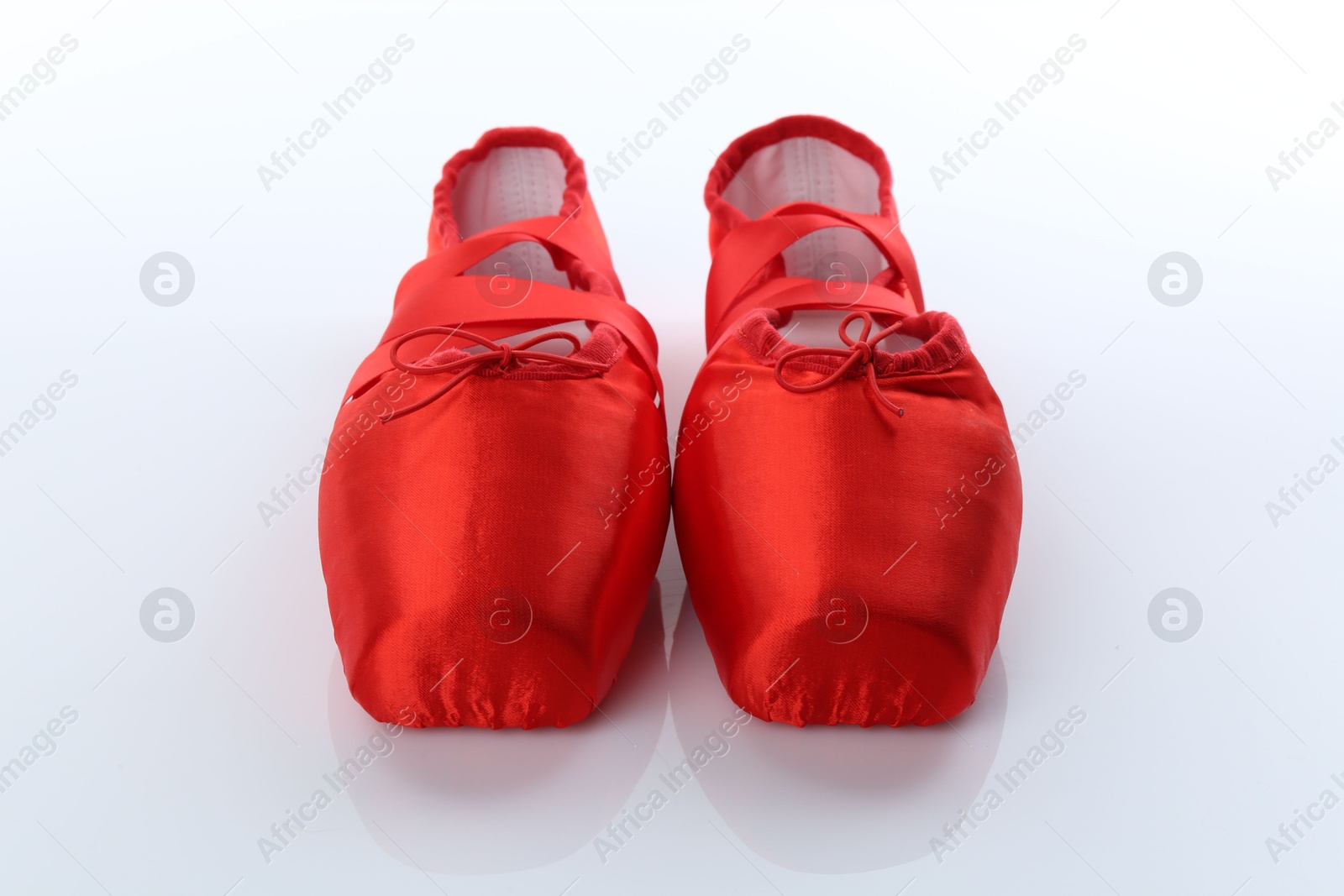 Photo of Pair of beautiful red pointe shoes isolated on white