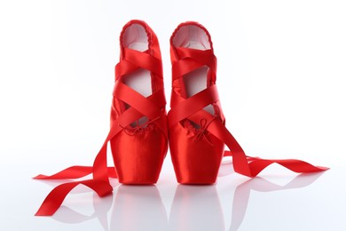 Photo of Pair of beautiful red pointe shoes isolated on white