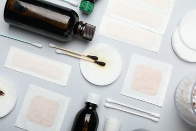 Photo of Topical iodine and other first aid kit components on light grey background, flat lay