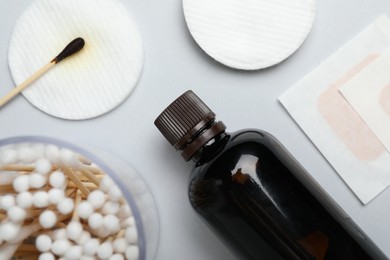 Photo of Topical iodine and other first aid kit components on light grey background, flat lay