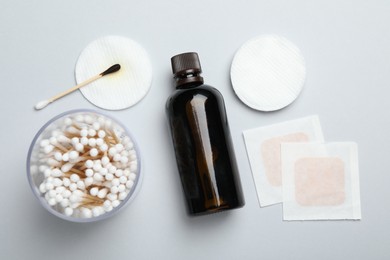 Photo of Topical iodine and other first aid kit components on light grey background, flat lay