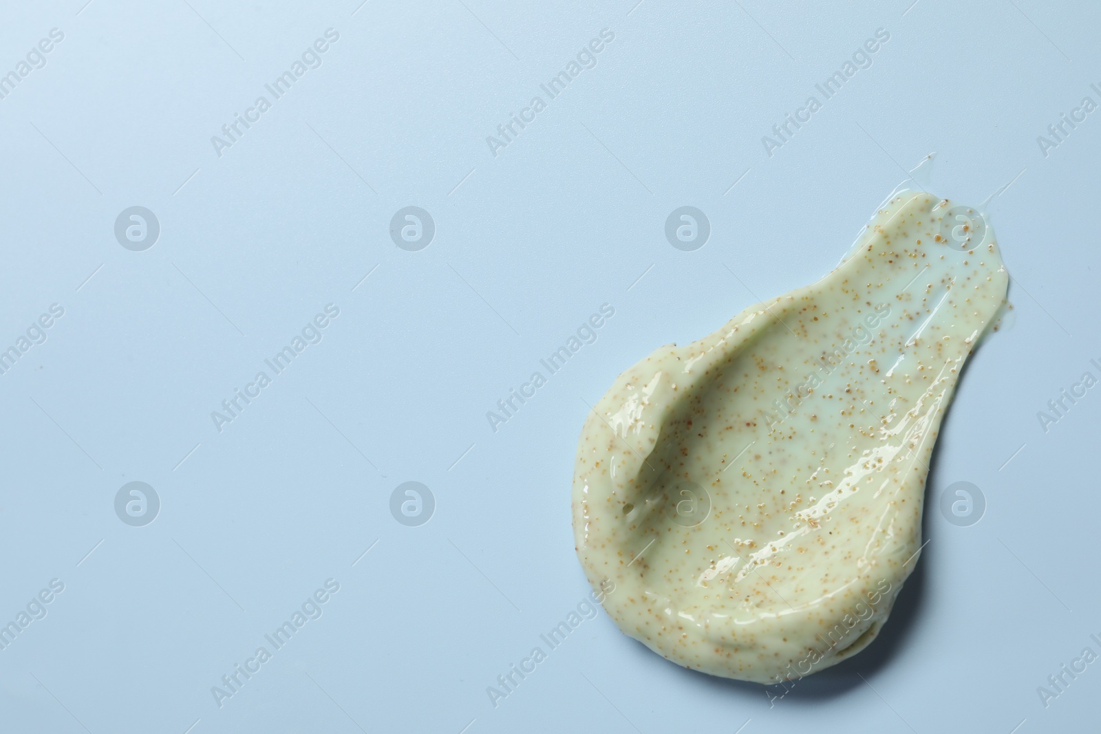 Photo of Smear of body scrub on light background, top view. Space for text