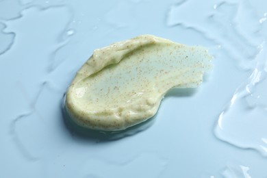 Photo of Smear of body scrub on light background, closeup