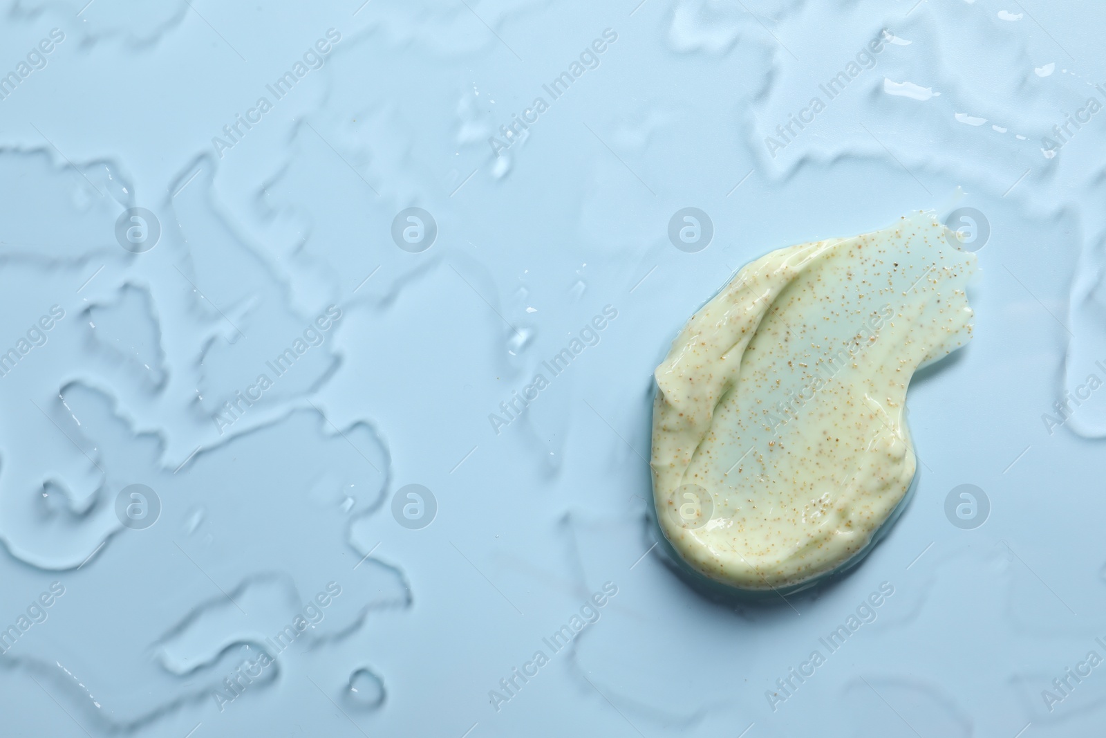 Photo of Smear of body scrub on light background, top view. Space for text