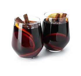 Photo of Tasty mulled wine with orange and spices isolated on white