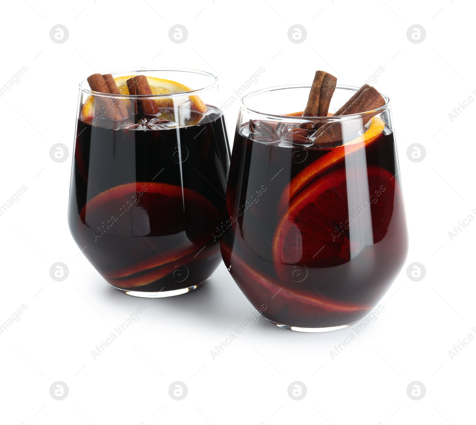 Photo of Tasty mulled wine with orange and spices isolated on white