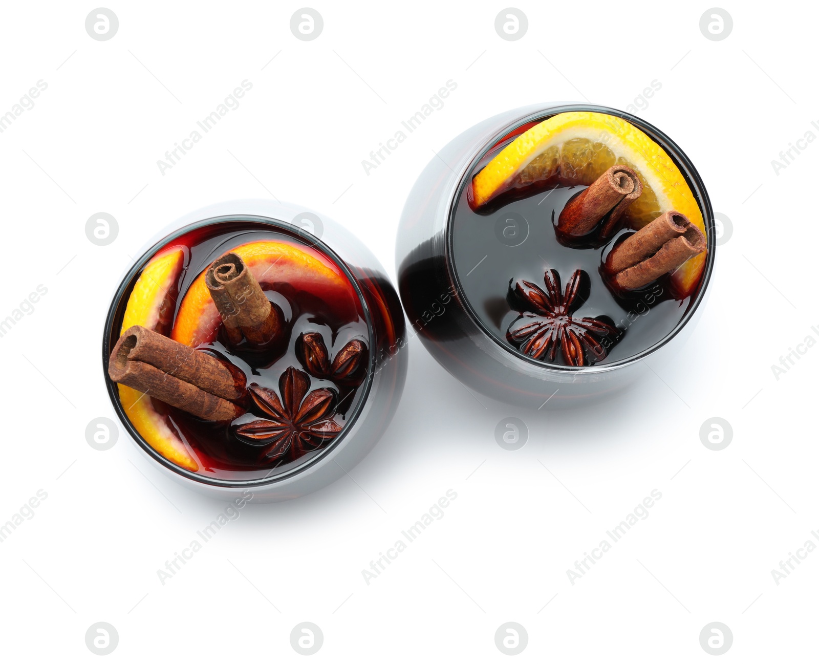 Photo of Tasty mulled wine with orange and spices isolated on white, top view