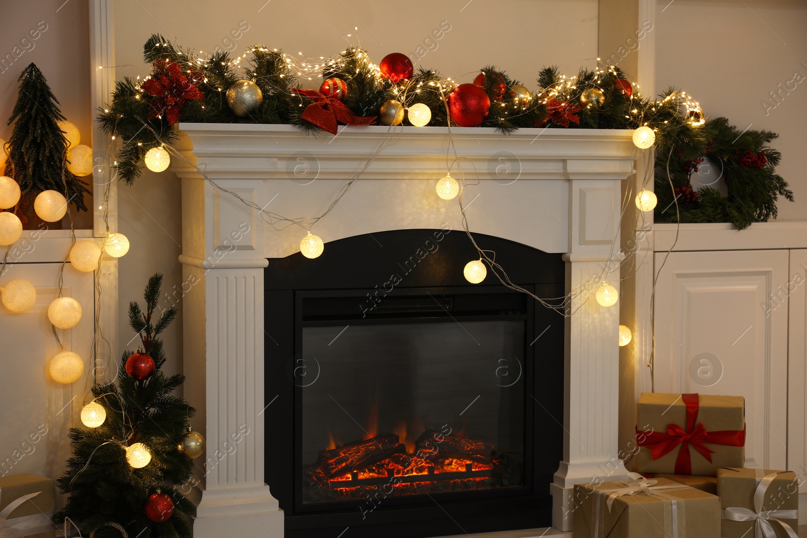 Photo of Stylish fireplace with Christmas decor and presents in cozy room