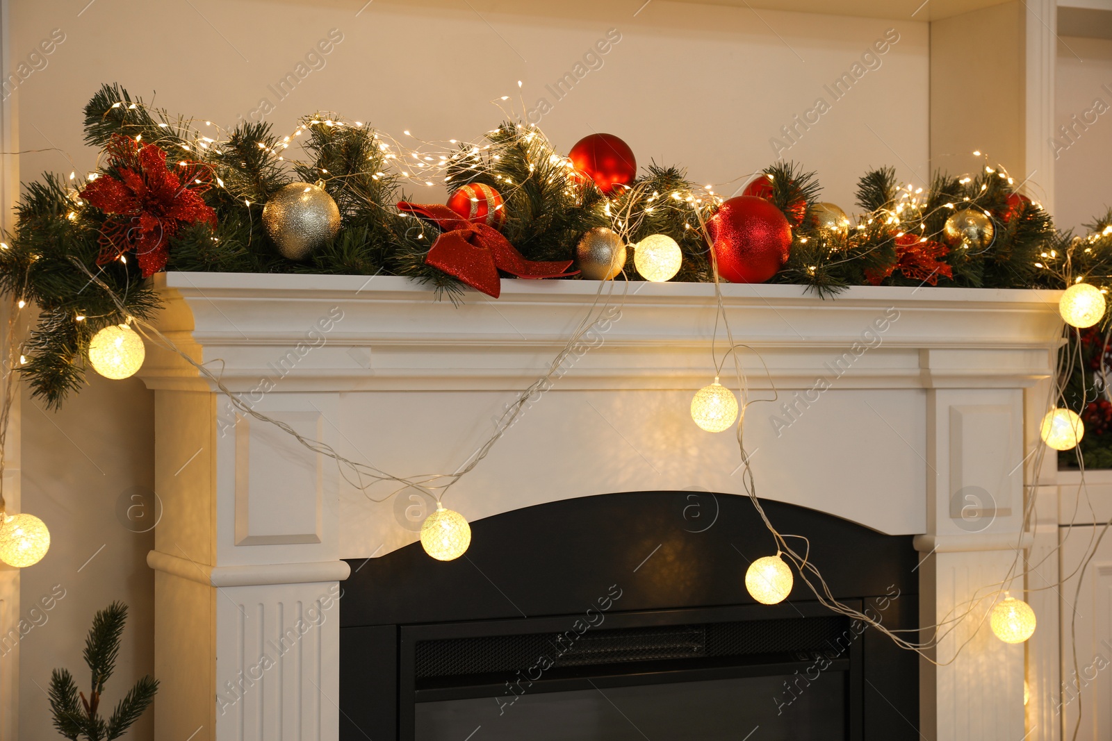 Photo of Stylish fireplace with Christmas decor in cozy room