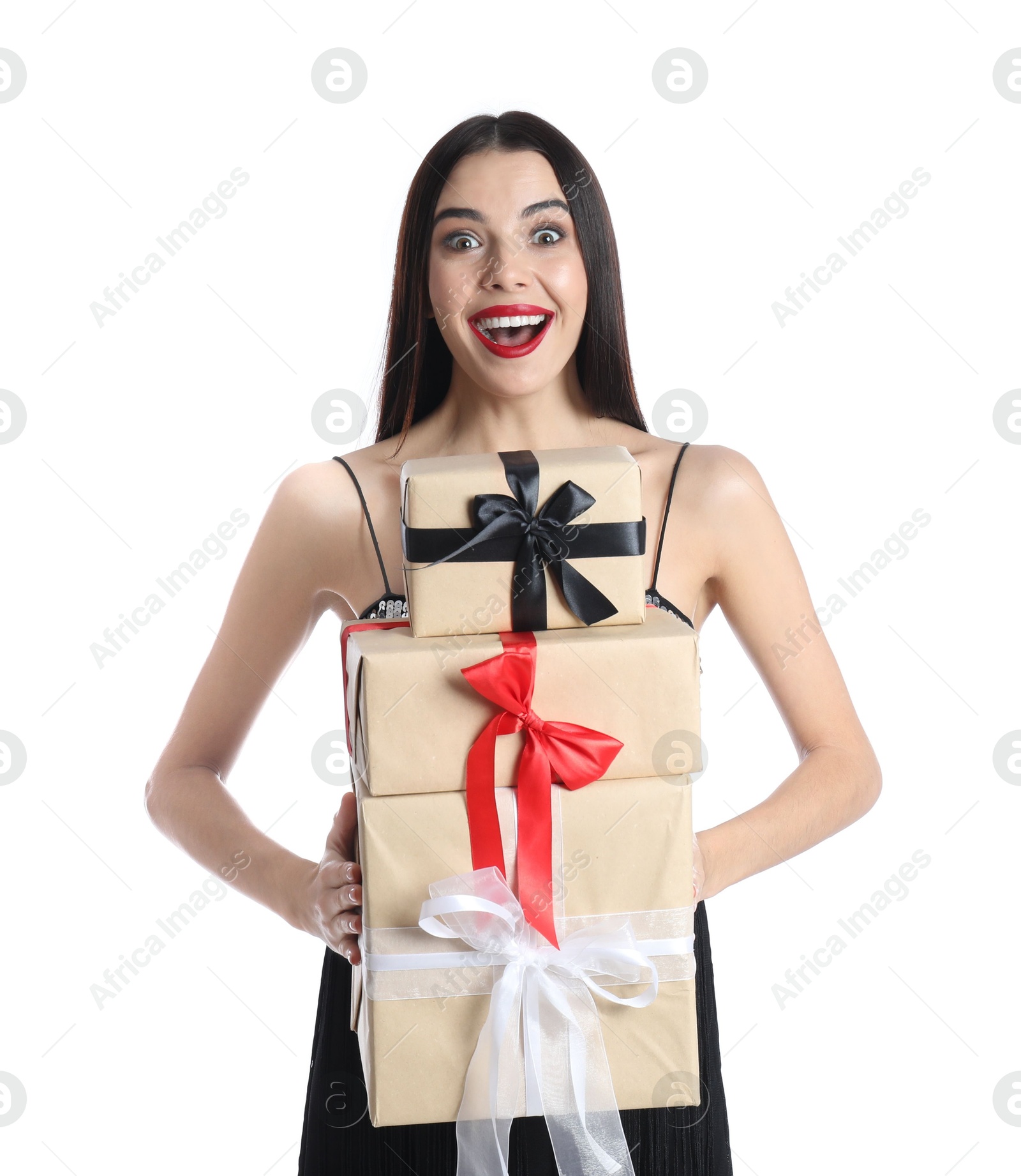 Photo of Excited woman in party dress holding Christmas gifts on white background