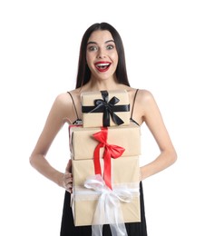 Photo of Excited woman in party dress holding Christmas gifts on white background