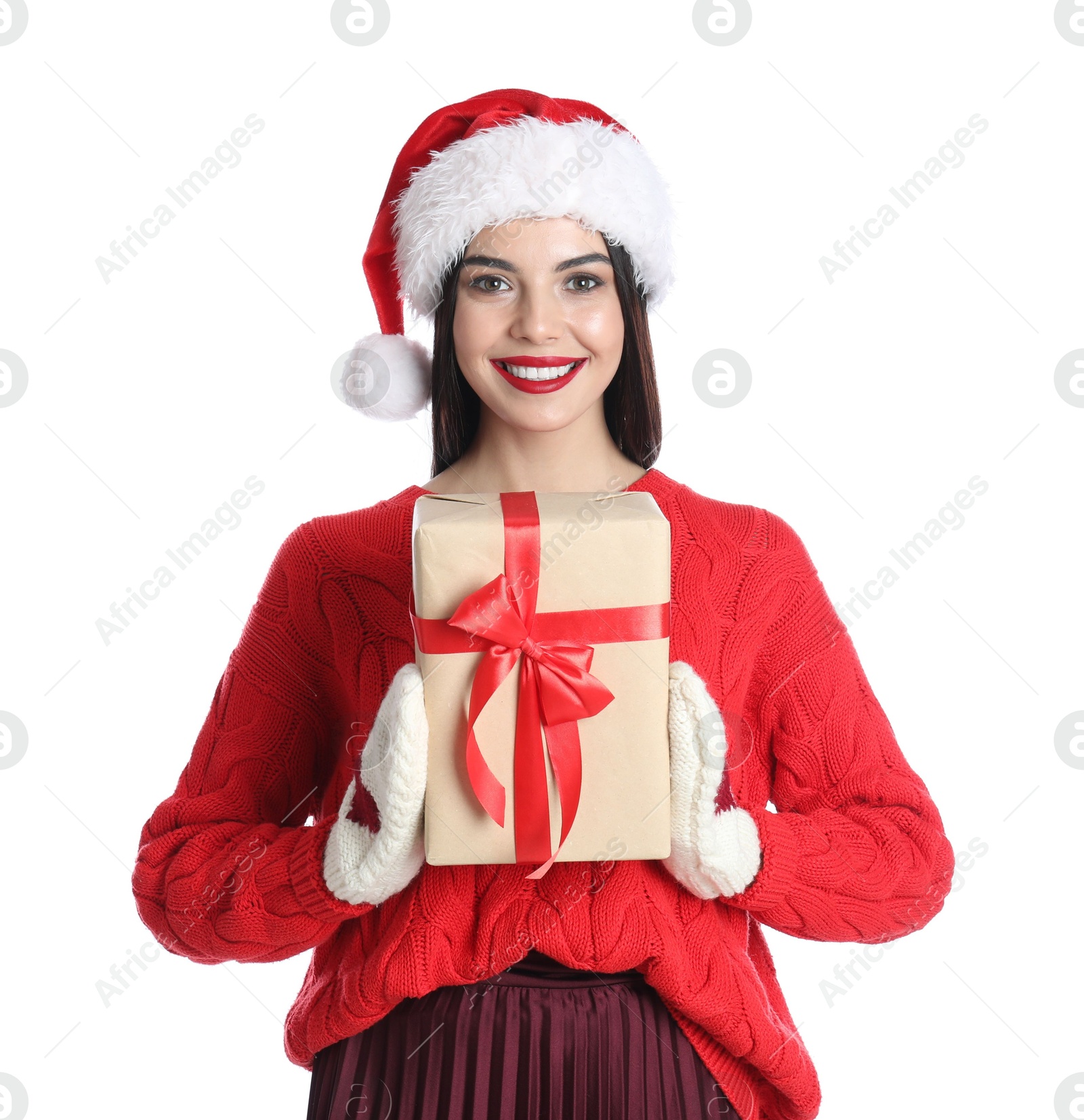 Photo of Woman in Santa hat, knitted mittens and red sweater holding Christmas gift on white background