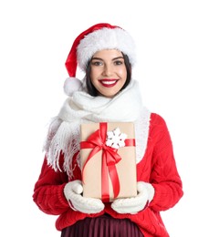 Woman in Santa hat, knitted mittens, scarf and red sweater holding Christmas gift on white background