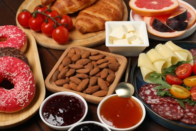 Photo of Different tasty food served for brunch on wooden table