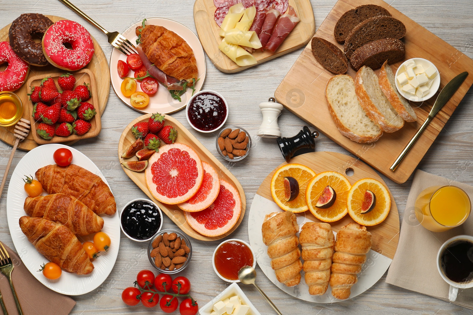 Photo of Different tasty food served for brunch on wooden table, flat lay