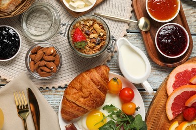 Photo of Different tasty food served for brunch on white wooden table, flat lay