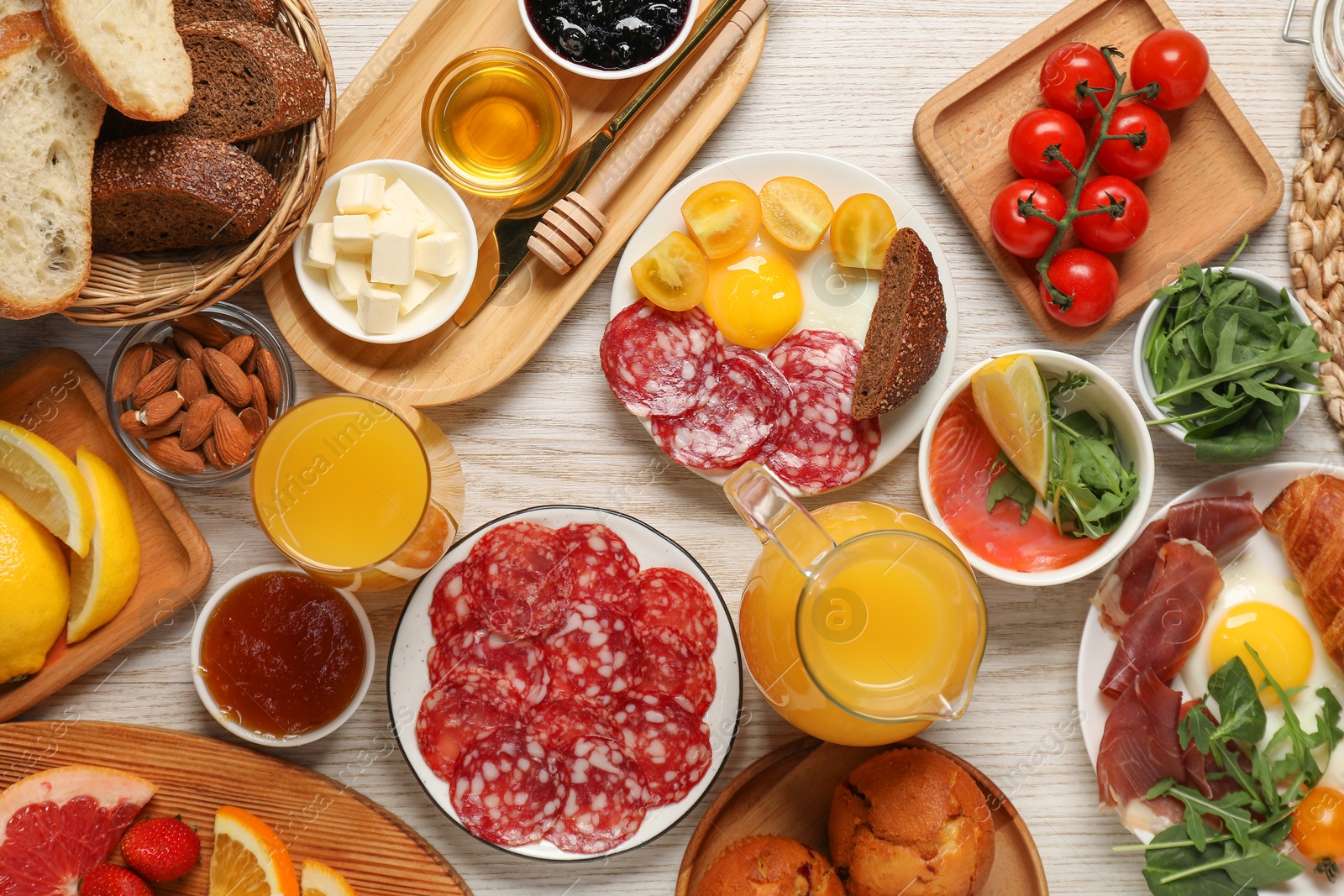 Photo of Different tasty food served for brunch on white wooden table, flat lay