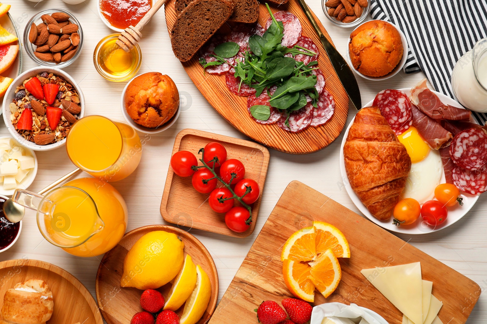 Photo of Different tasty food served for brunch on white wooden table, flat lay