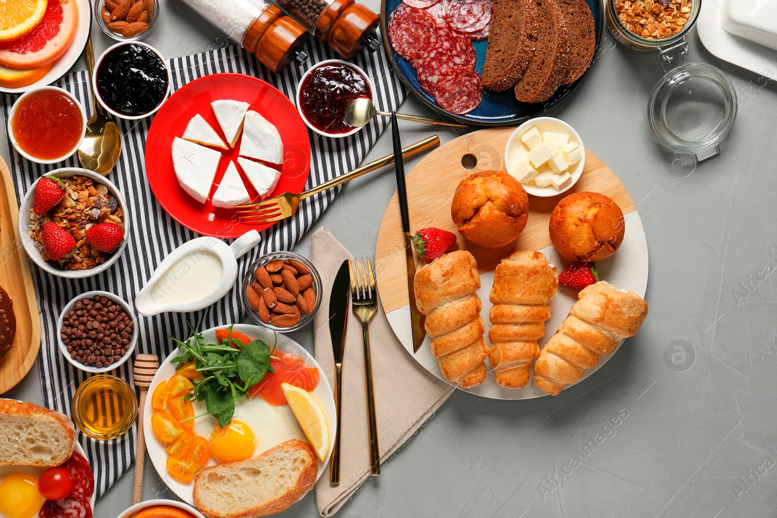 Photo of Different tasty food served for brunch on grey table, flat lay