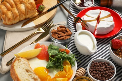 Photo of Different tasty food served for brunch on grey table, flat lay