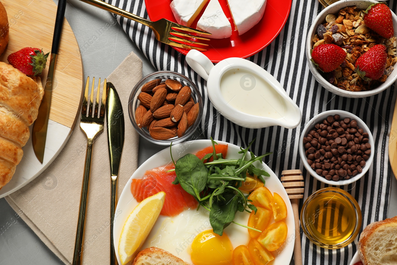 Photo of Different tasty food served for brunch on grey table, flat lay