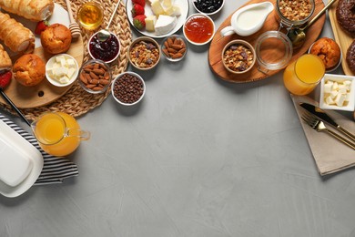 Photo of Different tasty food served for brunch on grey table, flat lay. Space for text