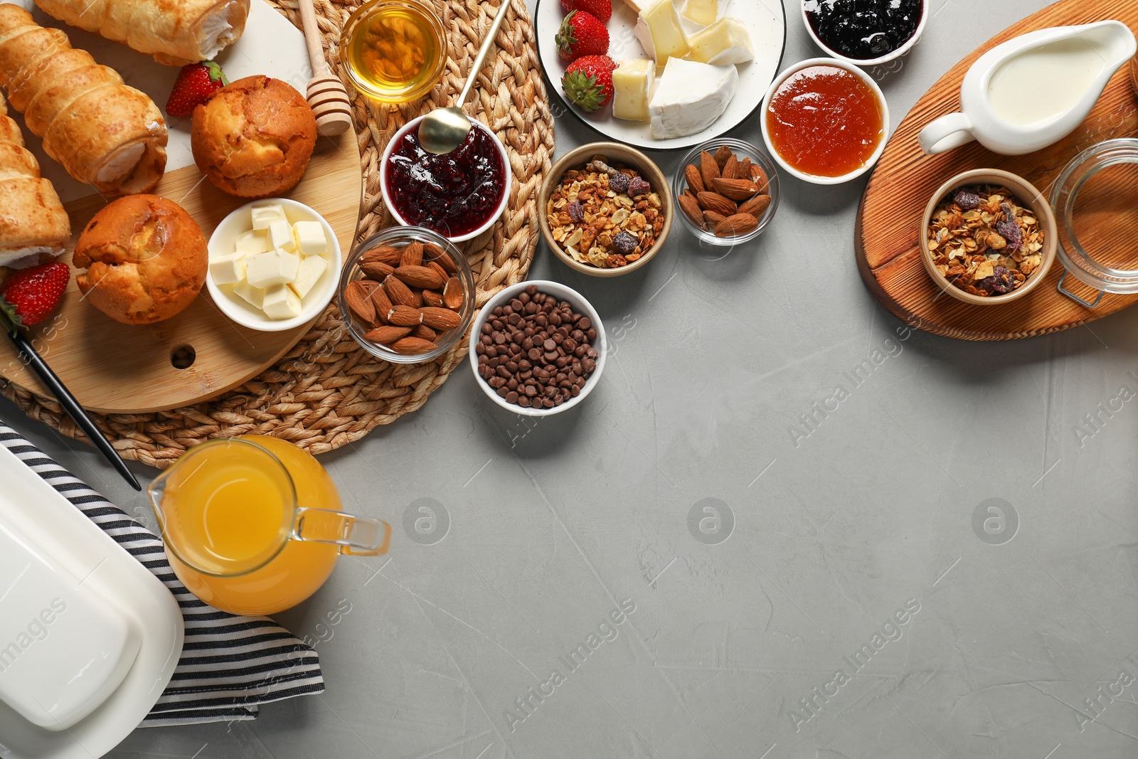 Photo of Different tasty food served for brunch on grey table, flat lay. Space for text