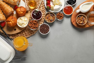 Photo of Different tasty food served for brunch on grey table, flat lay. Space for text