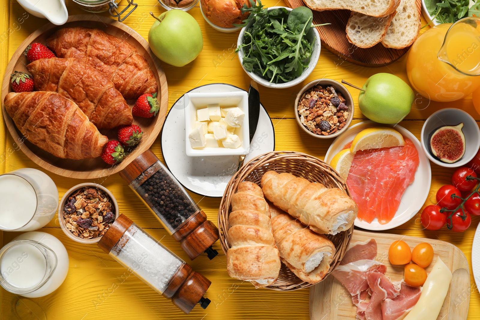 Photo of Different tasty food served for brunch on yellow wooden table, flat lay