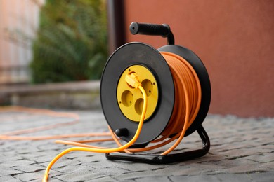 Photo of Extension cord reel on paved pathway outdoors