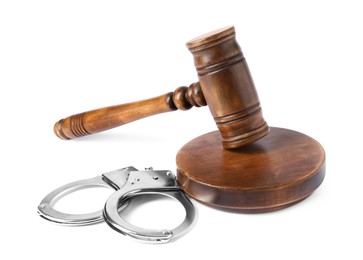 Photo of Handcuffs and judge's gavel isolated on white