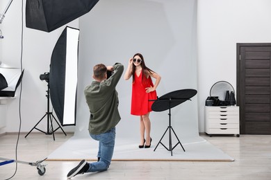 Photo of Photographer working with model in professional photo studio