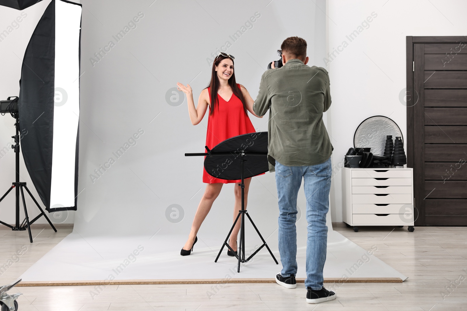 Photo of Photographer working with model in professional photo studio