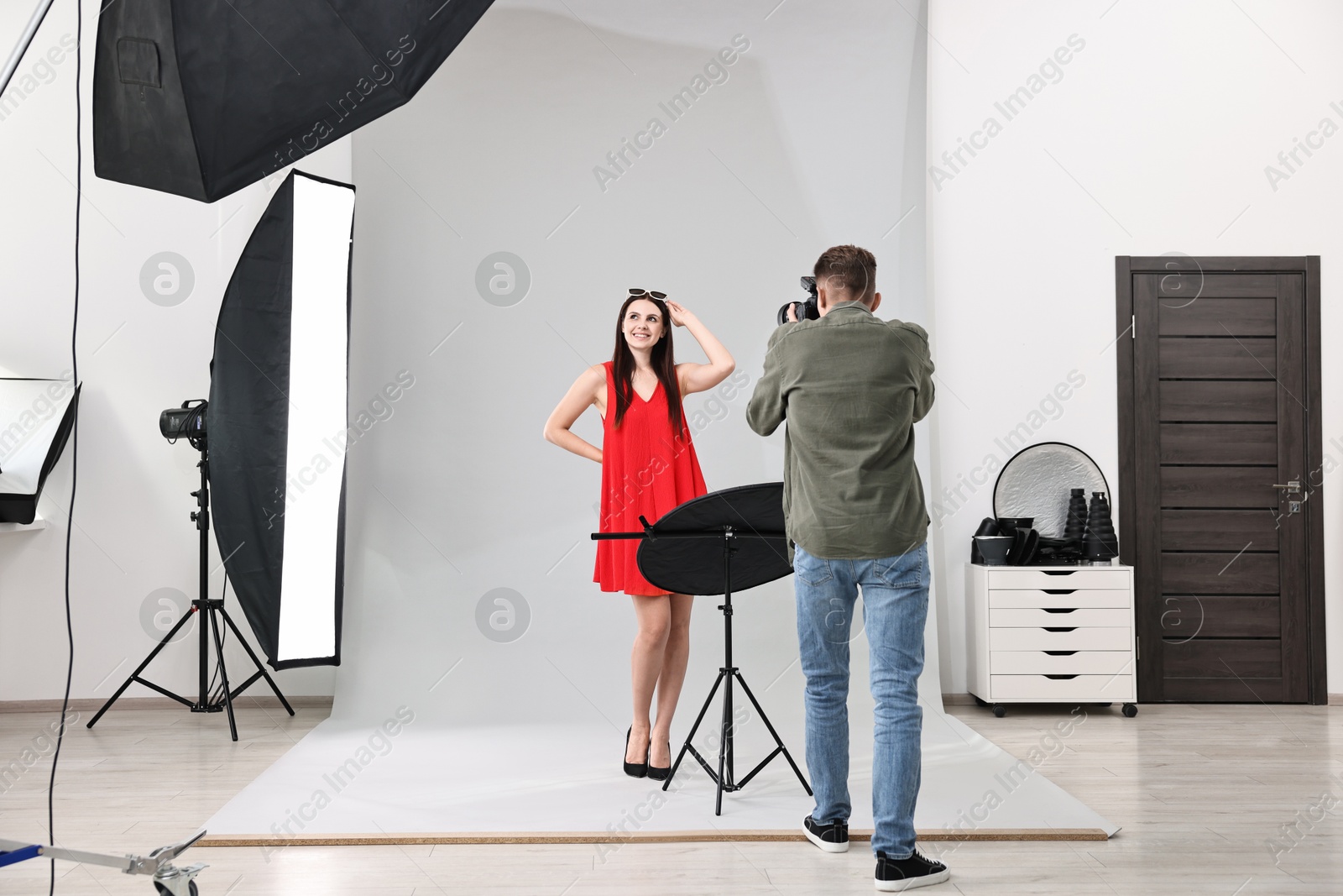 Photo of Photographer working with model in professional photo studio